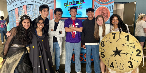 DI team, COURTNEY, in costume and with props, posing for a photo at Global Finals 2025. 