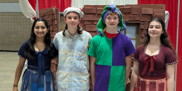 DI team, Chaotic Cardboard Caterpillars, pose for a photo in costume at Global Finals 2025. 