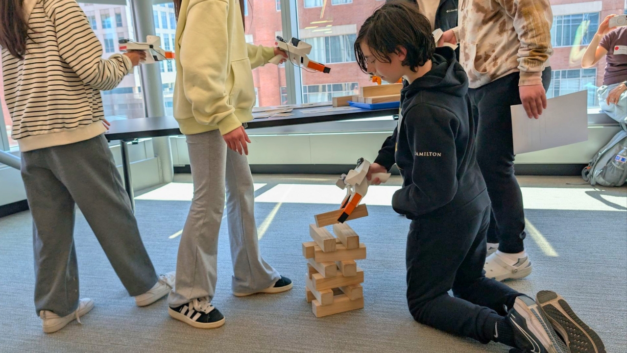 Student Building Jenga Tower at RAI Robot