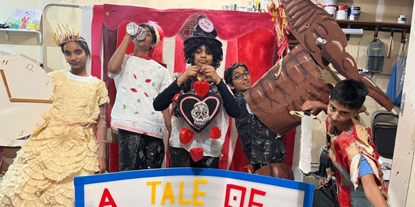 DI team, Dudette Mcgonigal's, pose for a fun photo in costume and with props for their DI presentation. 