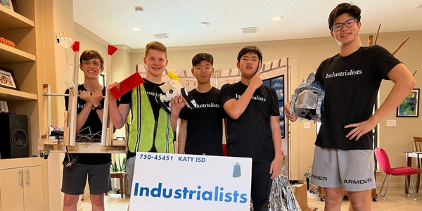DI team, Industrialists, holding their props and posing for a team photo. 