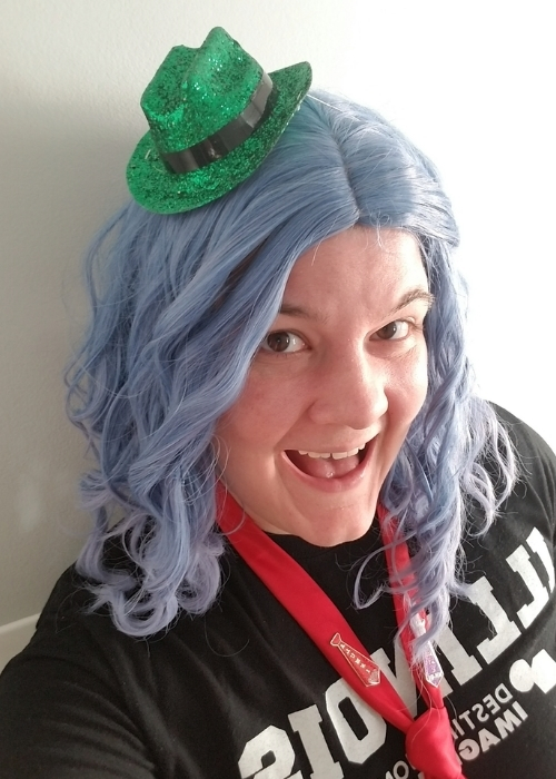 Kate Nylander poses in a tiny green hat for DI's Hats On For Creativity fundraising challenge