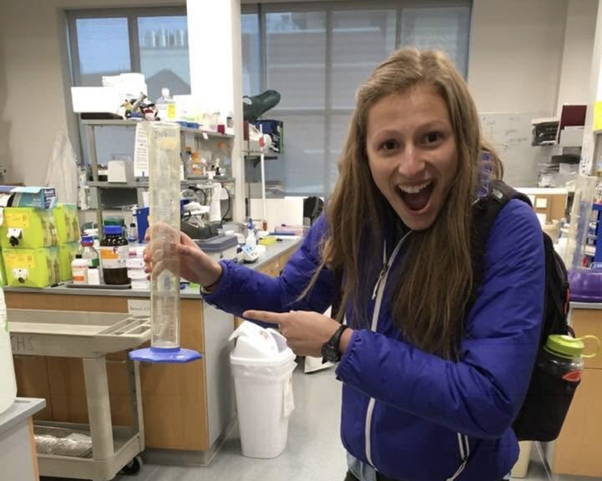 Leah Baker holds a graduated cylinder while in a laboratory at the University of Minnesota.