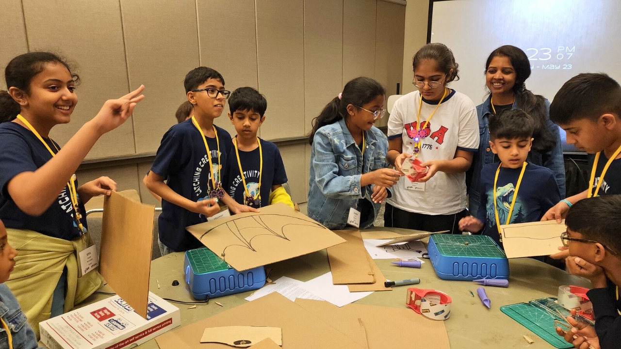 A group of students work together on a project-based learning activity at Destination Imagination's Global Finals event.