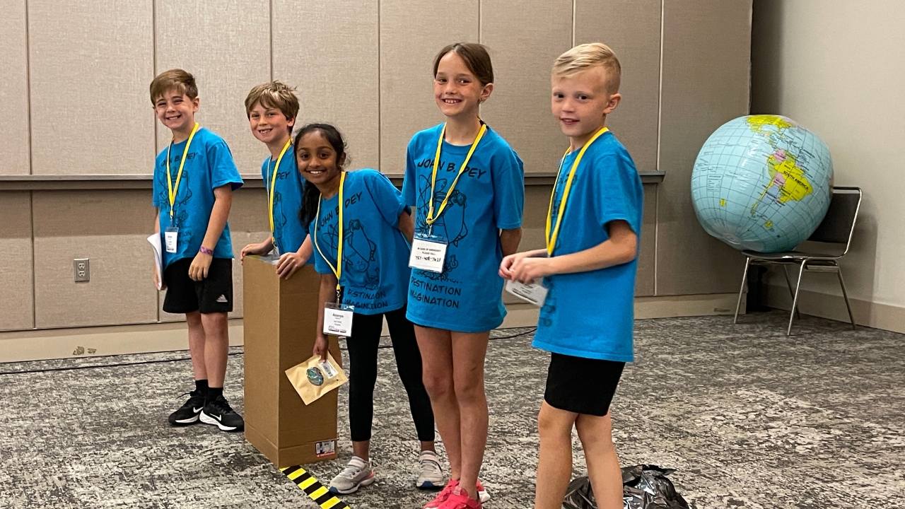 A Destination Imagination poses for a photo before their presentation at Global Finals.