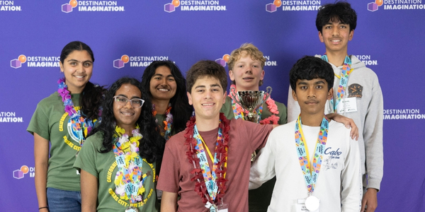 DI team, Tilted Towers, pose for a photo with their trophy at Global Finals 2025. 