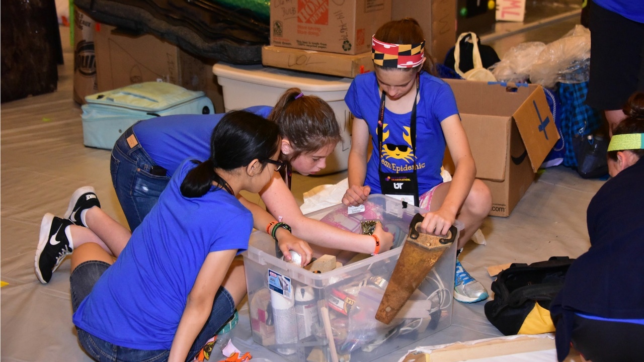 A Destination Imagination team from Maryland goes through a box of items used to fix and work on their Challenge solution, including a saw and spray paint.